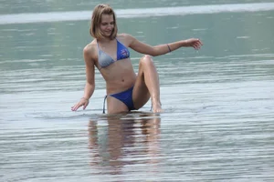 Skinny teen having fun in her little England bikini
