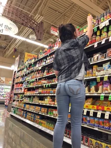 Sexy brunette grocery shopping in tight jeans