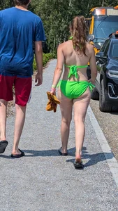 Beautiful Brown hair tight Girl in green bikini on the beach. oc