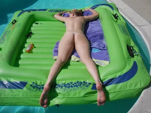 Topless Girl in Strings Lying on the Swimming Mattress