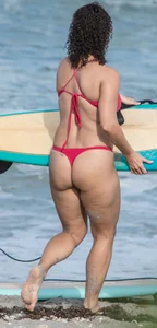 Thick brunette milf on the beach in red thong bikini