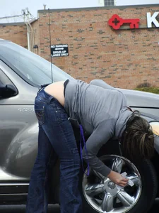 Girl cleaning her car in jeans and showing some cheetah print underwear