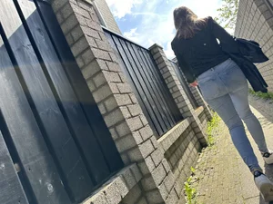 Sexy girl in tight blue jeans walking down a suburban street creepshots