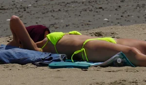 Sexy ass blonde milf on the beach in a thong with cameltoe and bending over