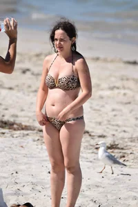 Brunette on the beach in a cheetah print bikini