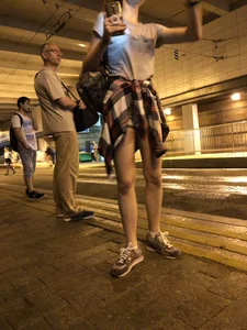 Cute Teen in Shorts on the Tram Stop
