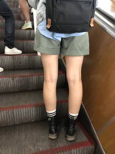 Skinny Female Legs in Shorts on the Subway Escalator Closeups