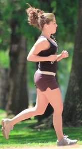 Cute girl running in short shorts