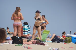 Two thick white girls in bikinis on the beach with big asses