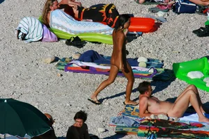 FKK Nudists playing in the water with floater