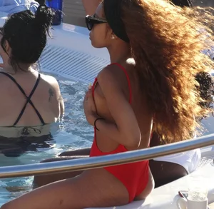 Sexy black girl in red swimsuit at the pool with side boob and a nice ass