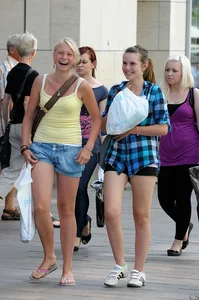 Pretty blonde and brunette friend walking in shorts