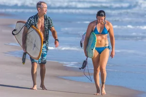 Candid girls surfing on the beach