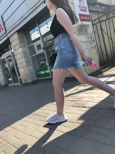 Hot chick wearing a fringed skirt walking up the stairs