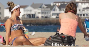 Beach babe in a blue bikini with thick friend in shorts