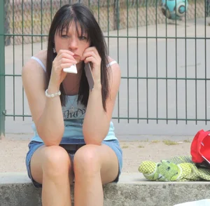 Brunette sitting upskirted showing her white lace panties