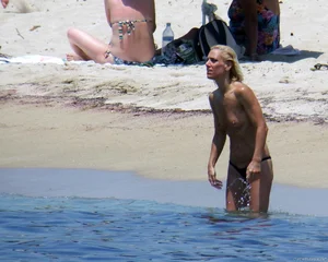 Small boobed topless milf on the beach