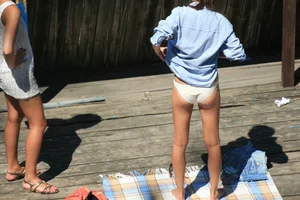 Two teens stripping and going topless to tan