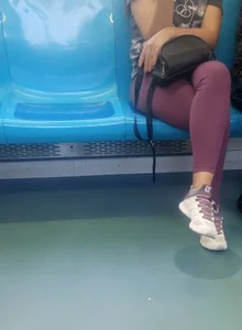 Candid Girl in Sneakers And Leggings Sitting in a Bus With Crossed Legs