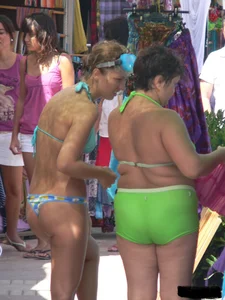 A bunch of hot babes on the beach in thong bikinis