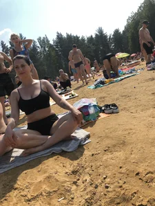 Hot Candid Girl in a Swimsuit Sitting With Crossed Legs on a Beach