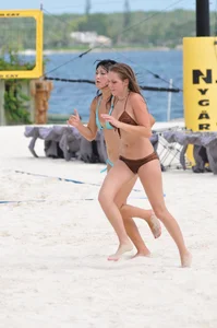 Two sexy girls playing tennis in bikinis