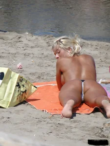 Tattooed blonde with big tits topless and in thong