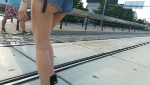 Girl walking in denim shorts showing some of her ass cheeks