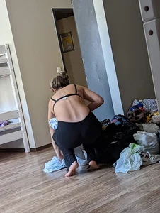 Squatting girl in a bra and leggings home creepshot