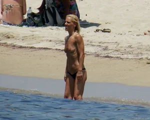 Small boobed topless milf on the beach