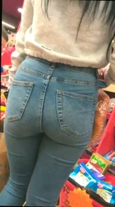Skinny brunette with a nice booty in line in tight jeans