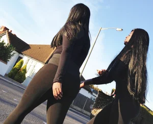 2 sexy black girls in leggings with nice asses