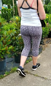 Milf booty in tight leggings shopping for plants