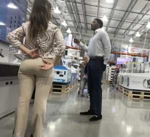 Plus Face shot - Gorgeous AT&T babe in beige pants  touching her ass with long red nails
