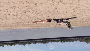 Girl laying out getting sun in a white thong bikini