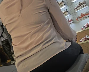 Latina milf in see leather see thru leggings sitting down.