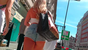 Blonde babe showing her ass cheeks on the street in shorts