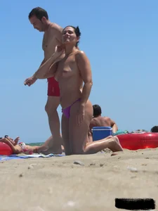 Purple thong topless lady on the beach gets oiled up by her husband