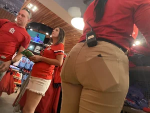 Bunch of girls in various outfits at a Cardinals baseball game
