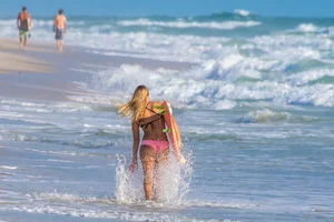 Candid girls surfing on the beach