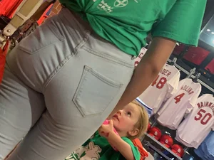 Bunch of girls in various outfits at a Cardinals baseball game