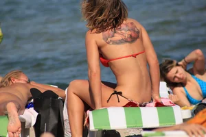 A couple sexy girls laying out on the beach