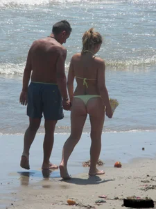 Sexy blonde on the beach in a yellow thong bikini