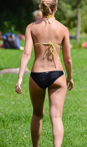 Sexy blonde girl in the park playing volleyball in her skimpy bikini