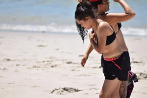 Beach girl can't keep her tits in her bikini