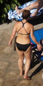 Milf laying out in black bikini by the pool