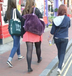 Girl in a pink skirt and stockings accidentally showing some cheek
