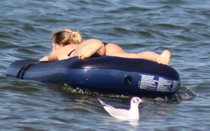 Black thong bikini blonde with a nice ass out on a tube in the water