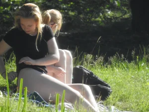 Two sexy friends in black bikinis laying out