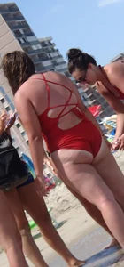 Fat chick on the beach in a red swimsuit